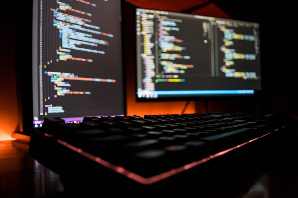 Stock photo of a computer in a dark room