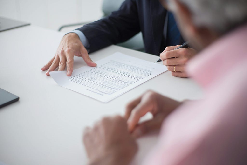 Stock photo of someone signing a document
